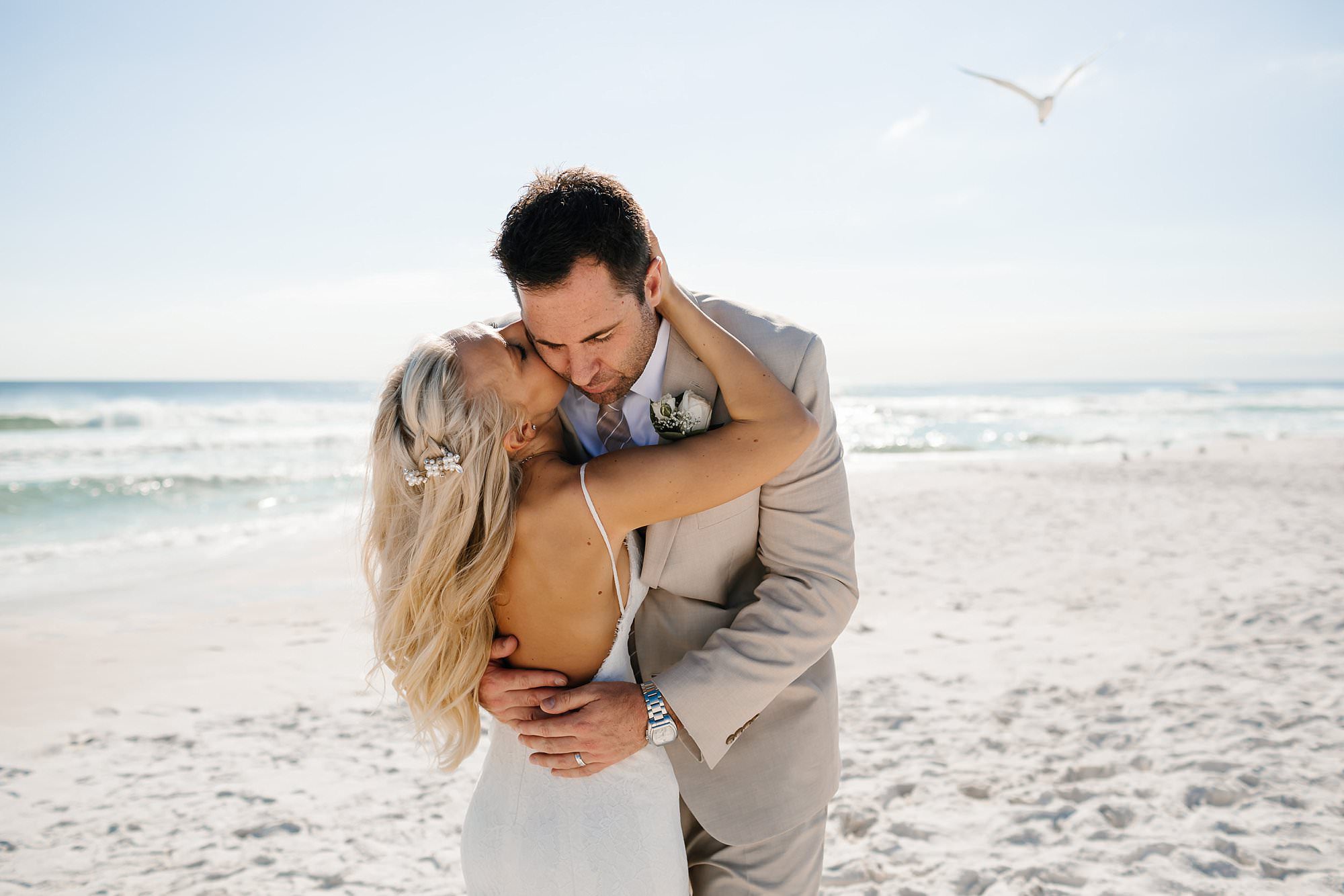 Portraits of bride and groom embracing on the beach Destin Florida