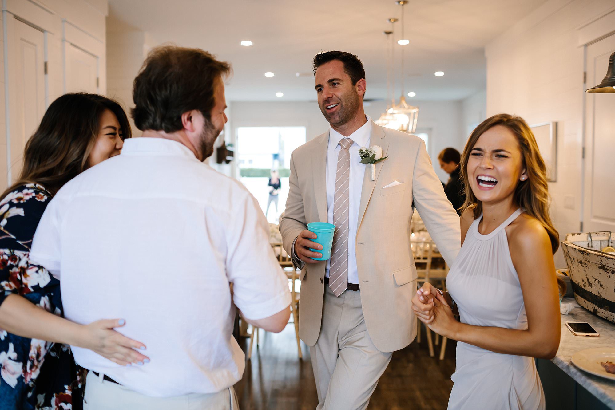 Groom entertains guests during cocktail hour