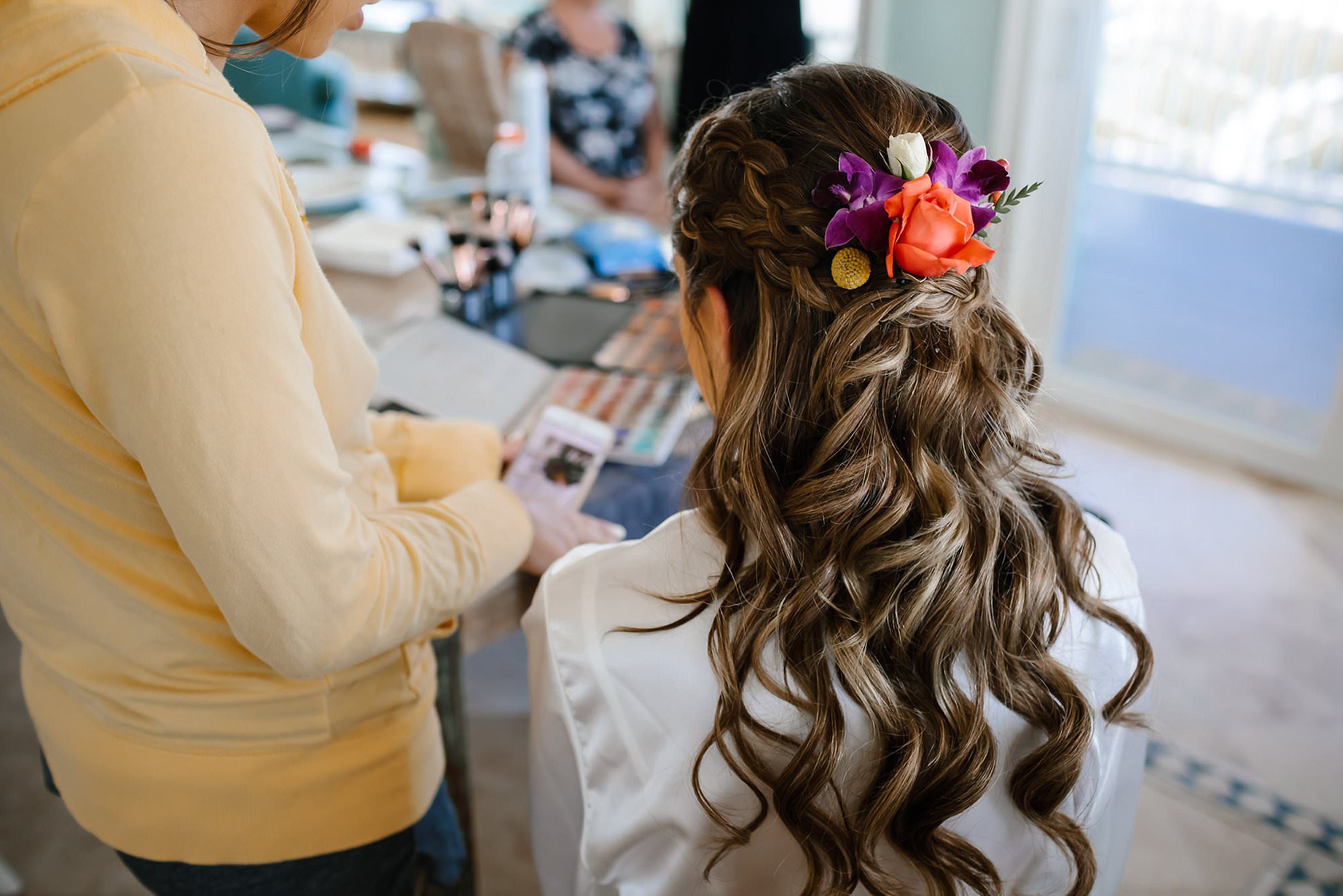 Bridal preparations showing flowers in brides hair