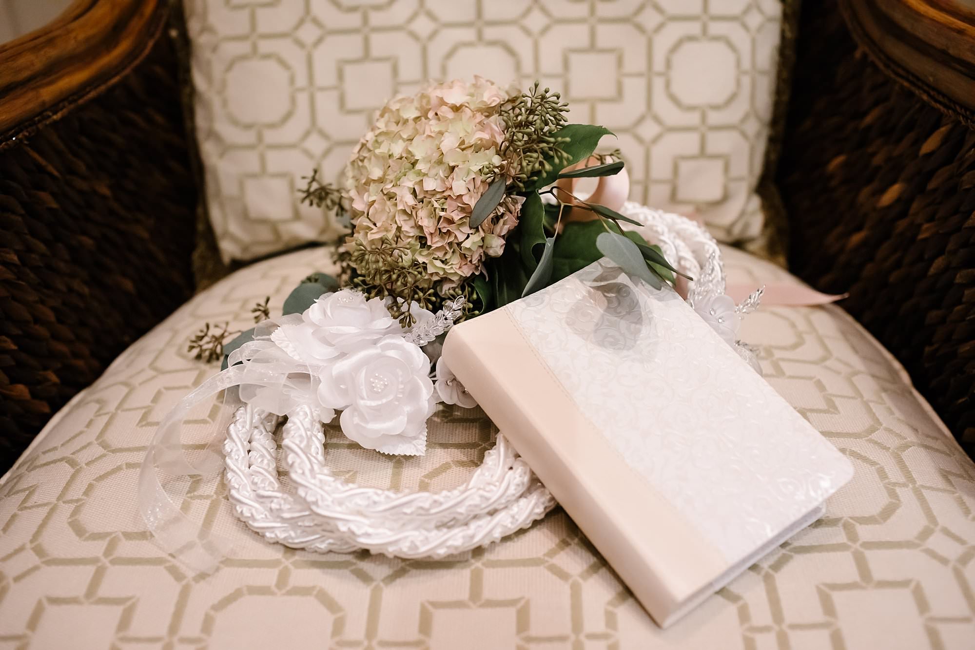 Detail photo of bridesmaid bouquet of hydrangea and seeded eucalyptus , white lasso and wedding bible
