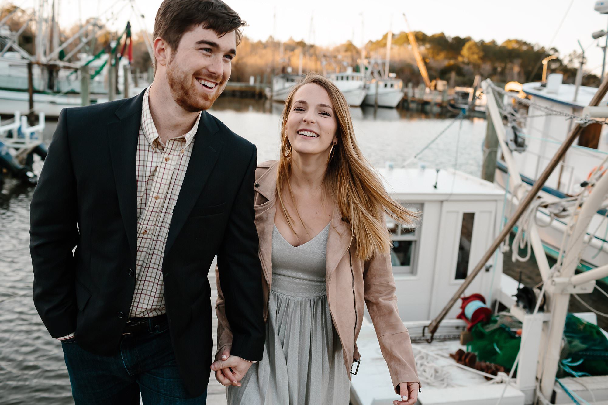 Turner and Megan hold hands leaving boat slip at the end of Market St in Apalachicola
