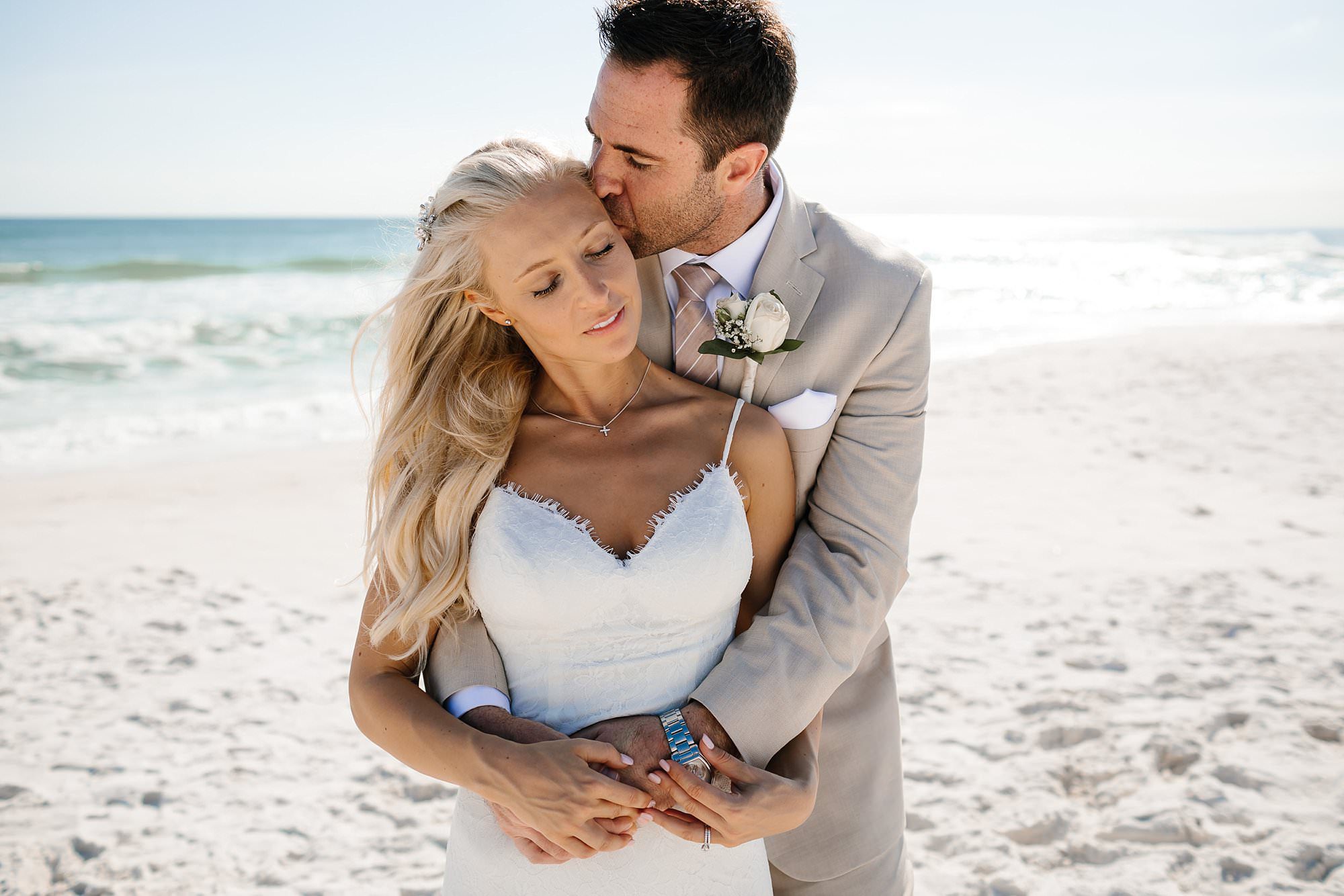 Portraits of bride and groom embracing on the beach Destin Florida