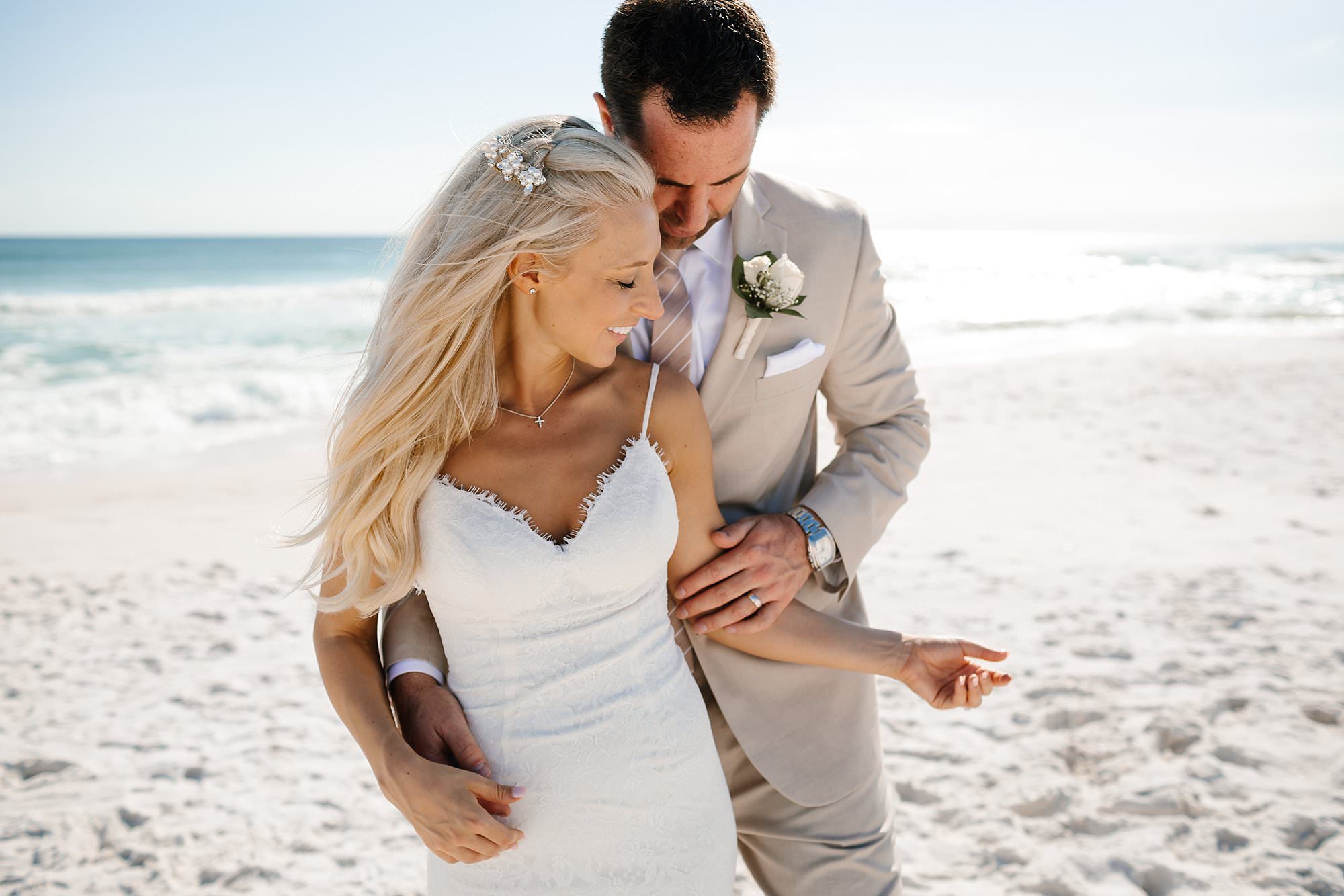 Portraits of bride and groom embracing on the beach Destin Florida