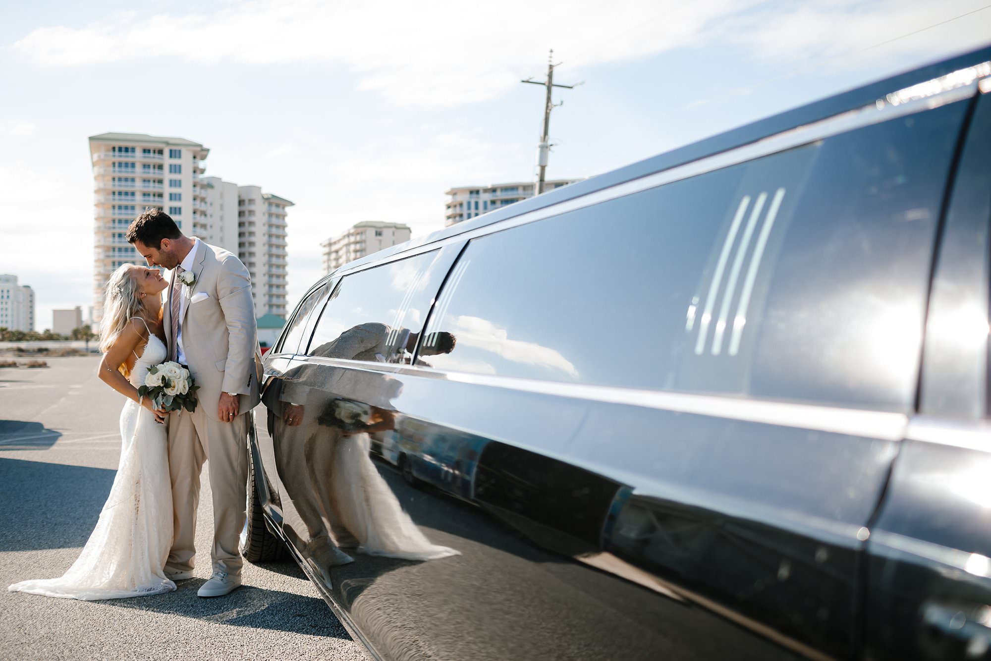 Bride and Groom reflected in the the side of 654 limo Destin Florida