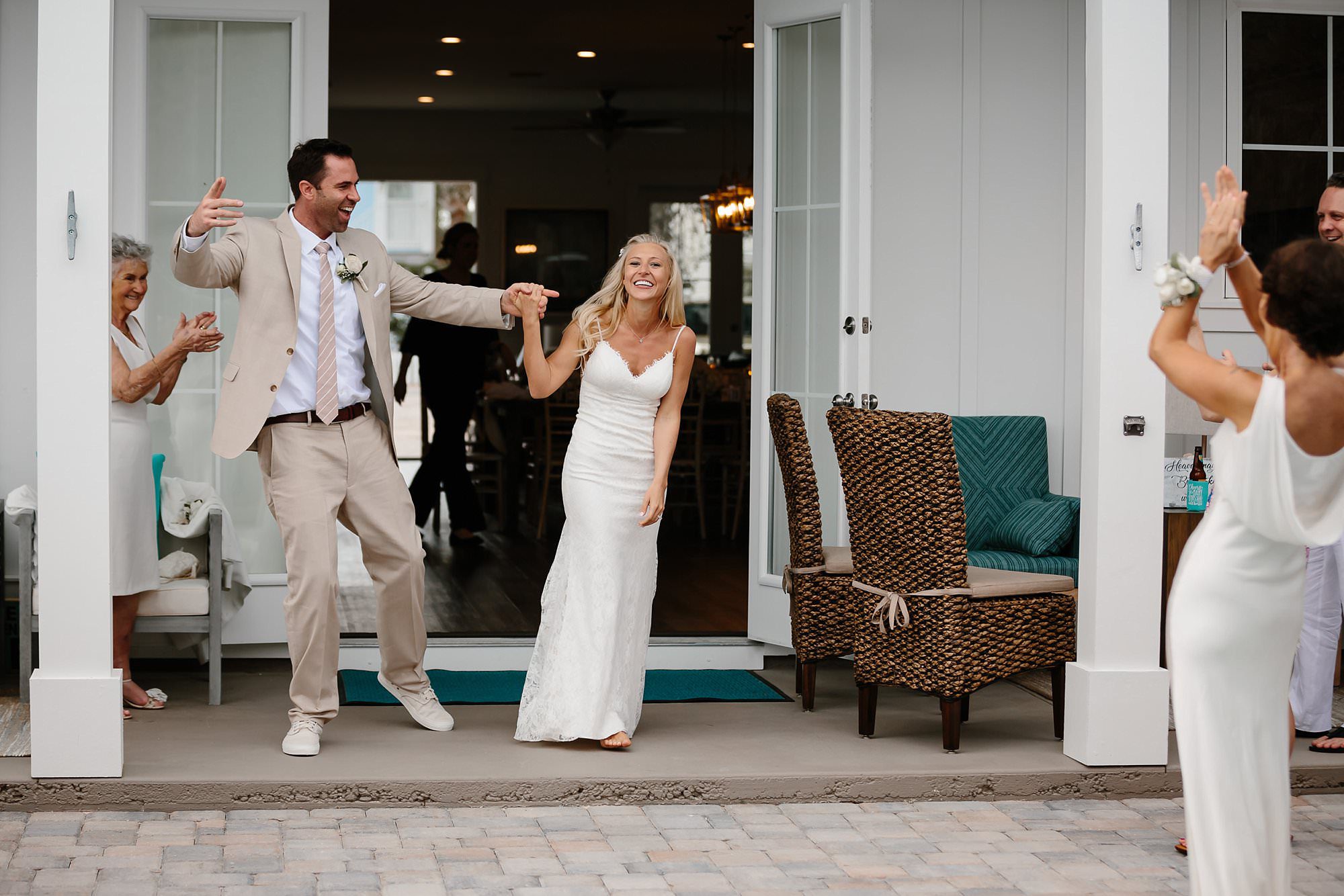 Bride and Groom grand entrance into wedding reception at beach house in Destin