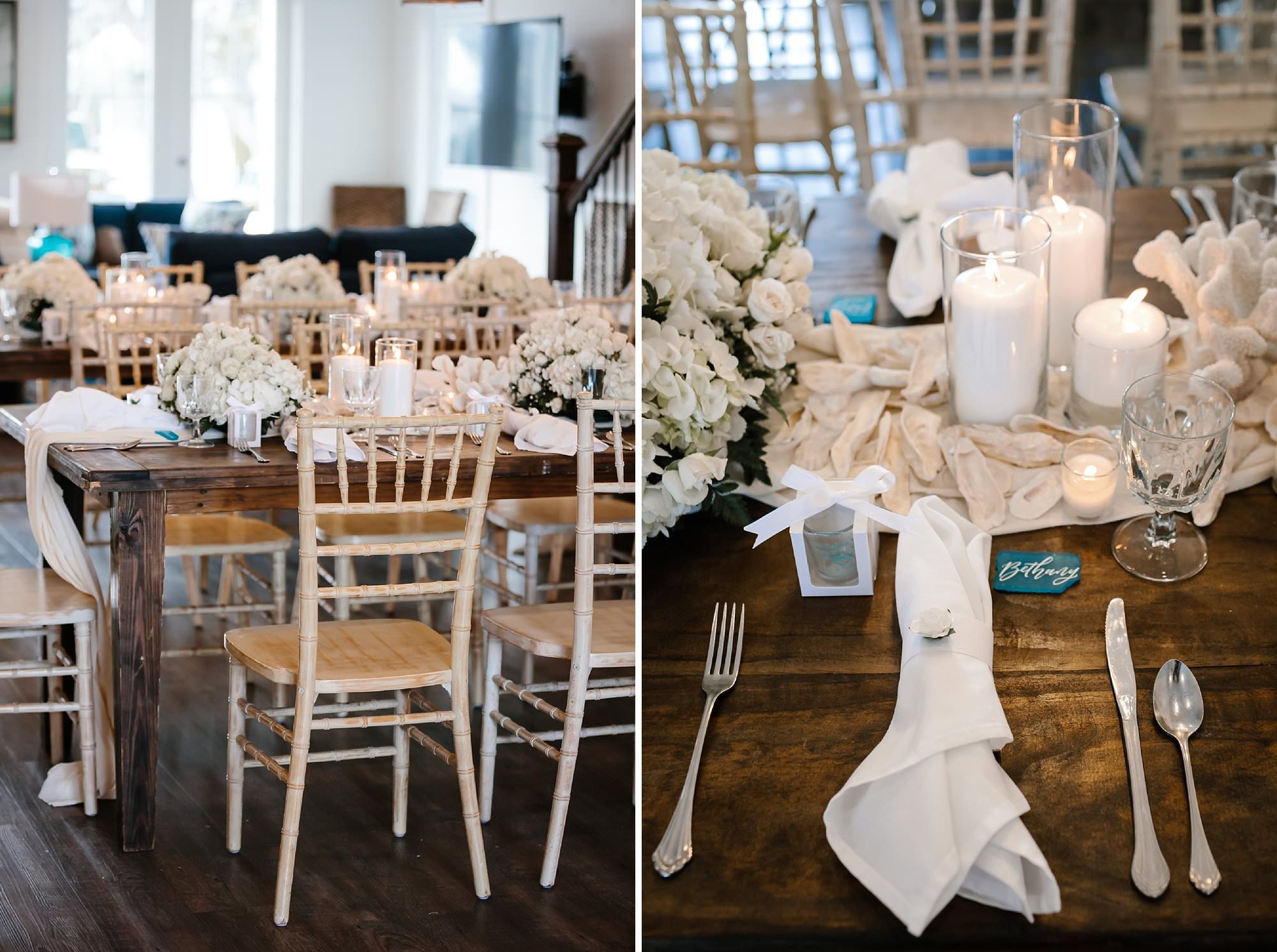 Wedding reception table decor of dark wood farm table set with white rose centerpieces white shells, candles, shot glass favors, white linens and aqua sea glass place cards