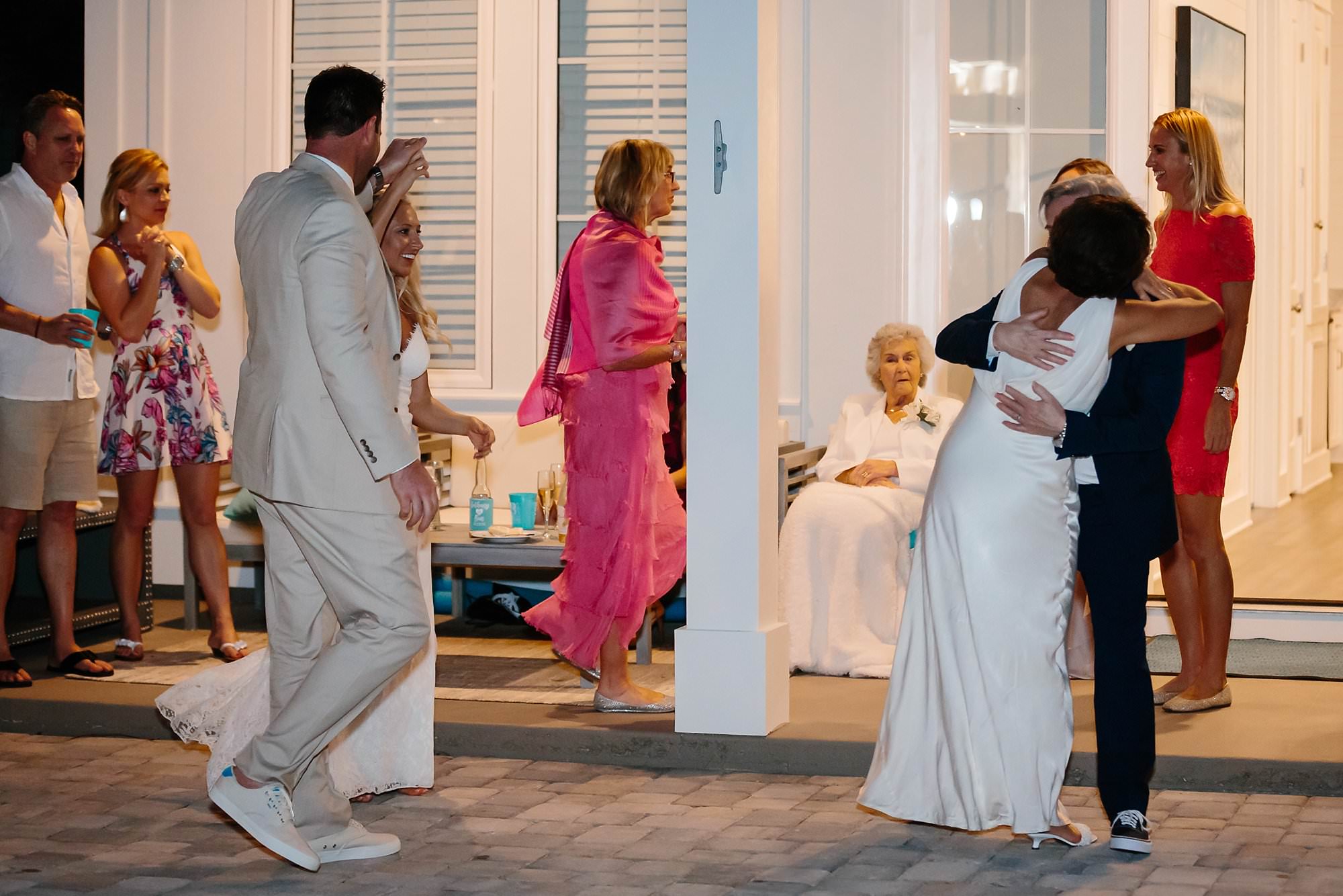 Groom spins brides durning first dance while brides parents join dancefloor