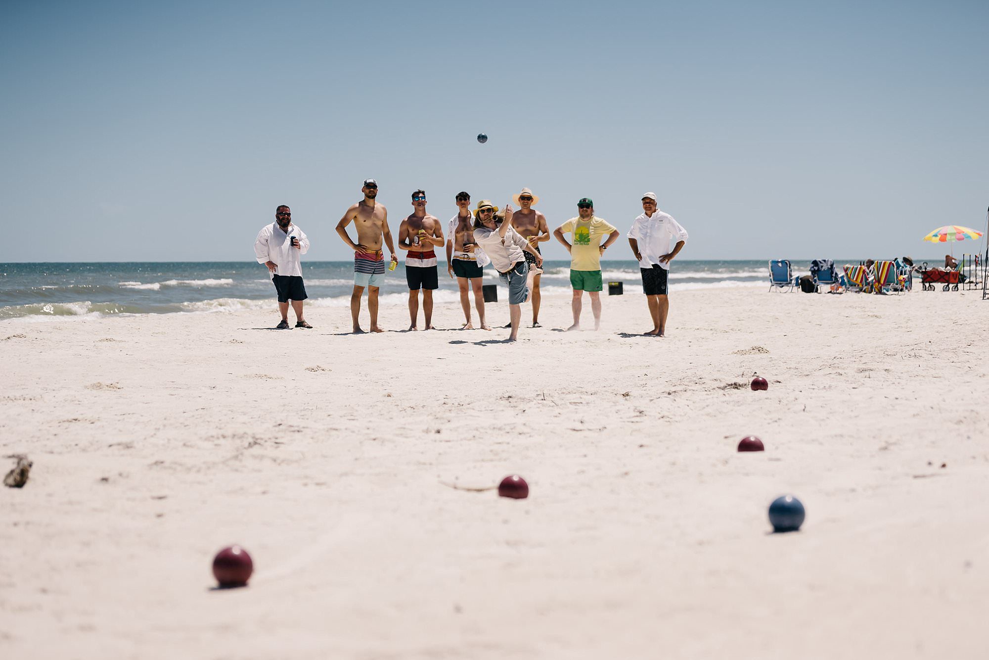 Grooms party playing bocce ball on the beach