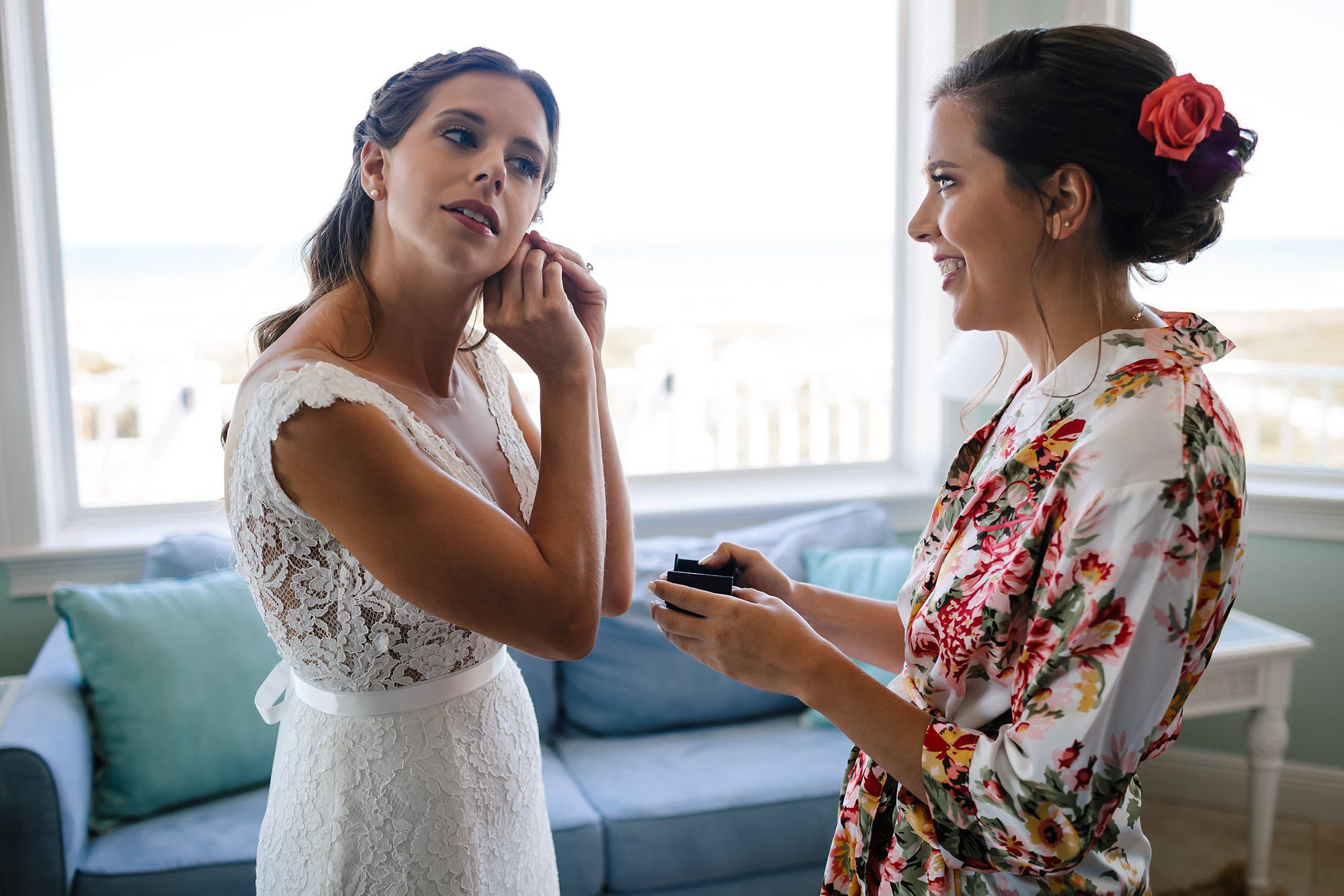 Bride and sister putting on earrings
