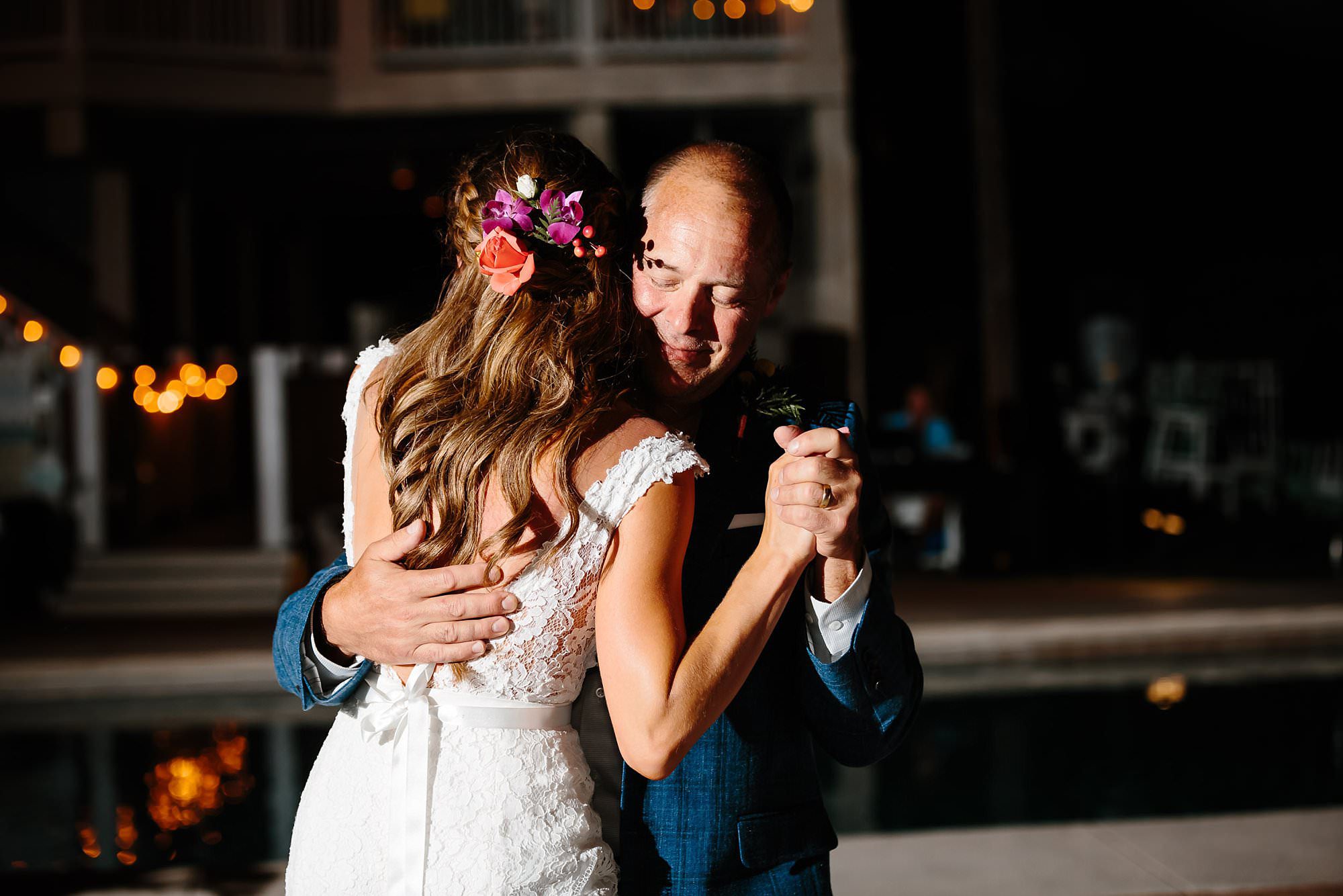 Father daughter dance at outdoor reception around pool at Aisle of Palms beach house on St. George Island