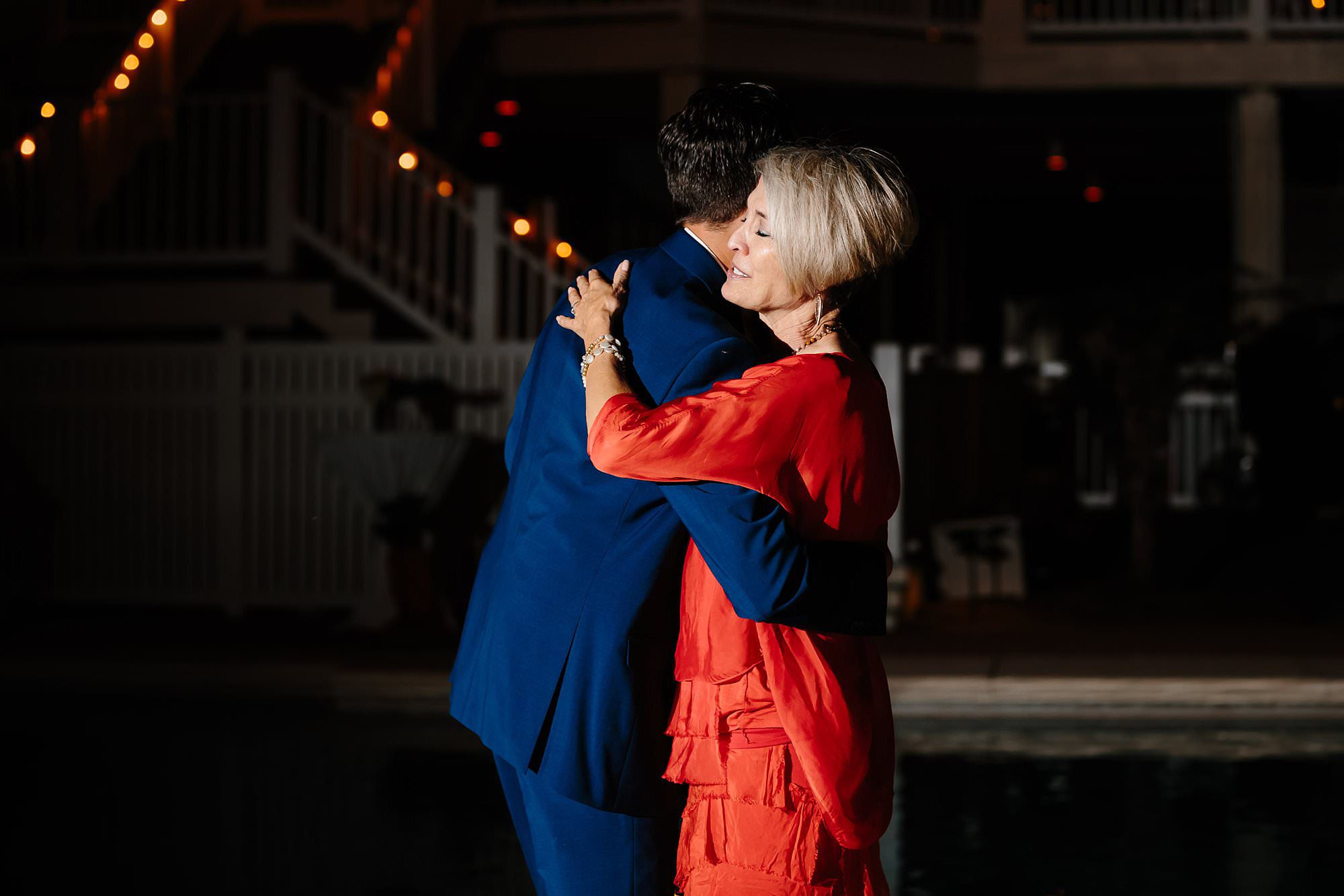 Mother son dance at outdoor reception around pool at Aisle of Palms beach house on St. George Island