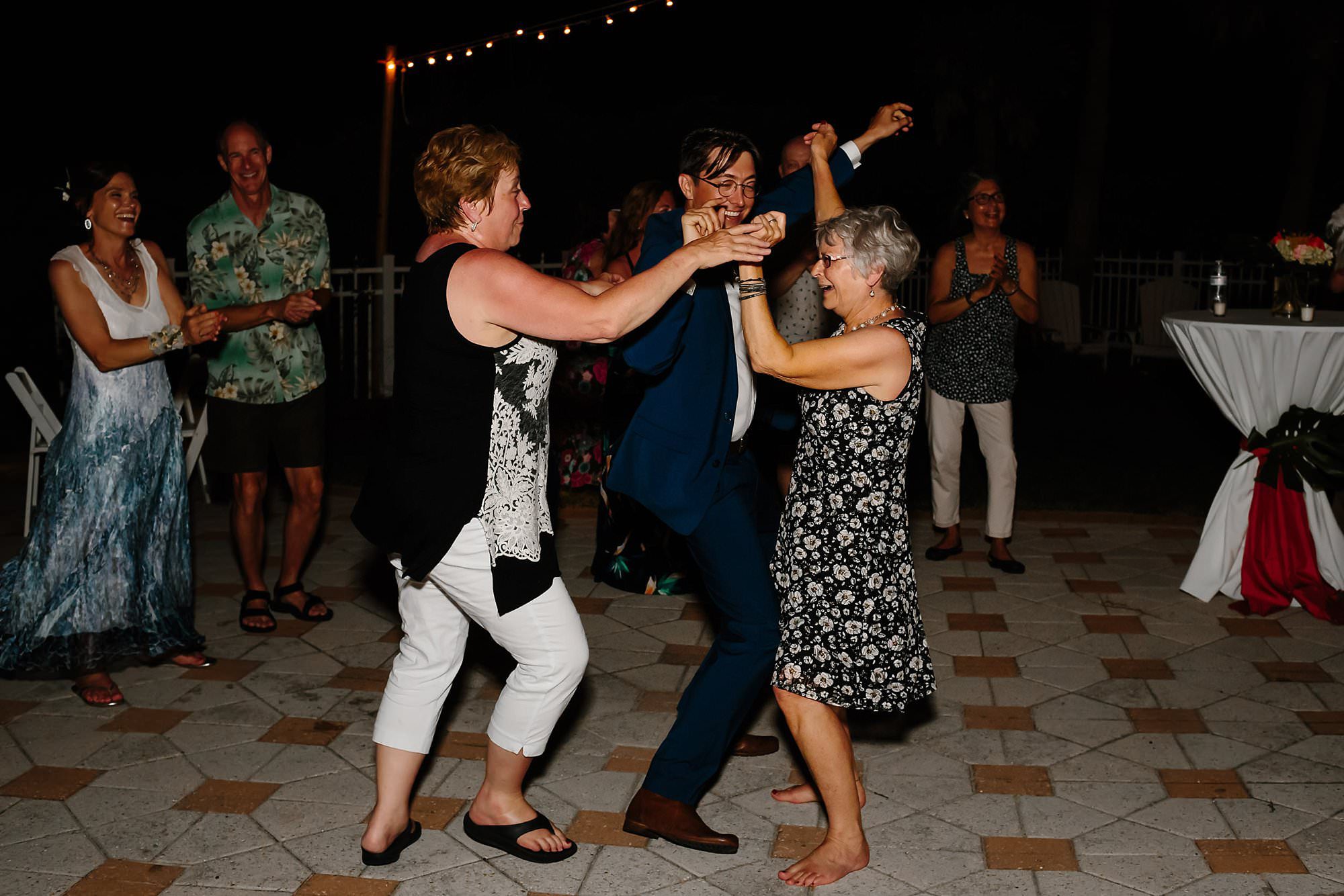 Fun dancing at outdoor reception around pool at Aisle of Palms beach house on St. George Island