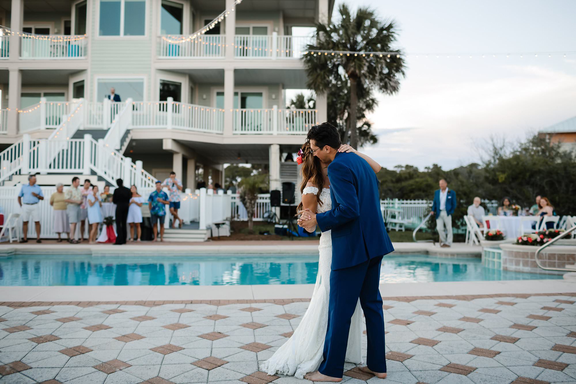 First dance at outdoor reception around pool at Aisle of Palms beach house on St. George Island