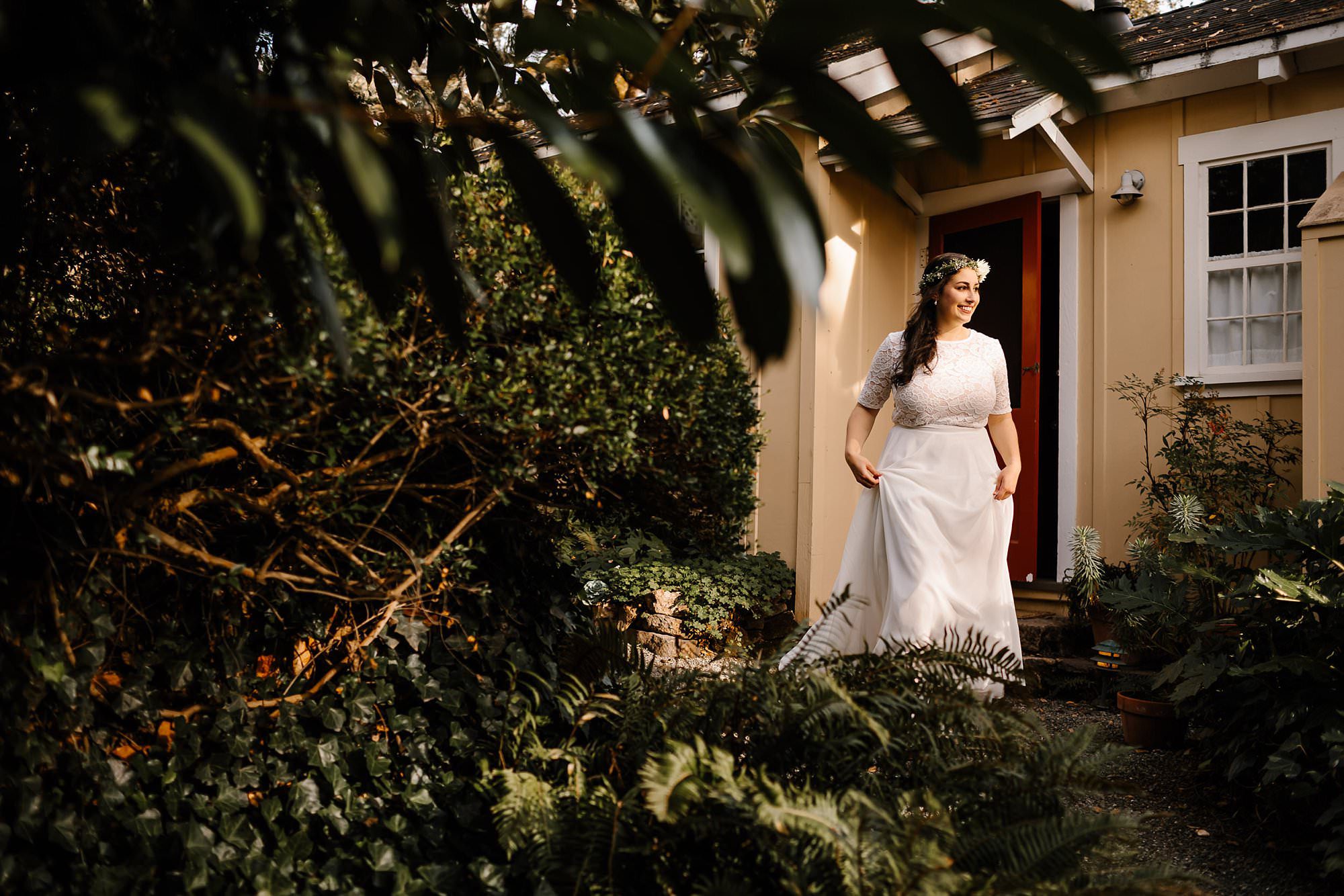 Bride leaving little yellow cottage at Beltane Ranch on her way to courtyard for elopement