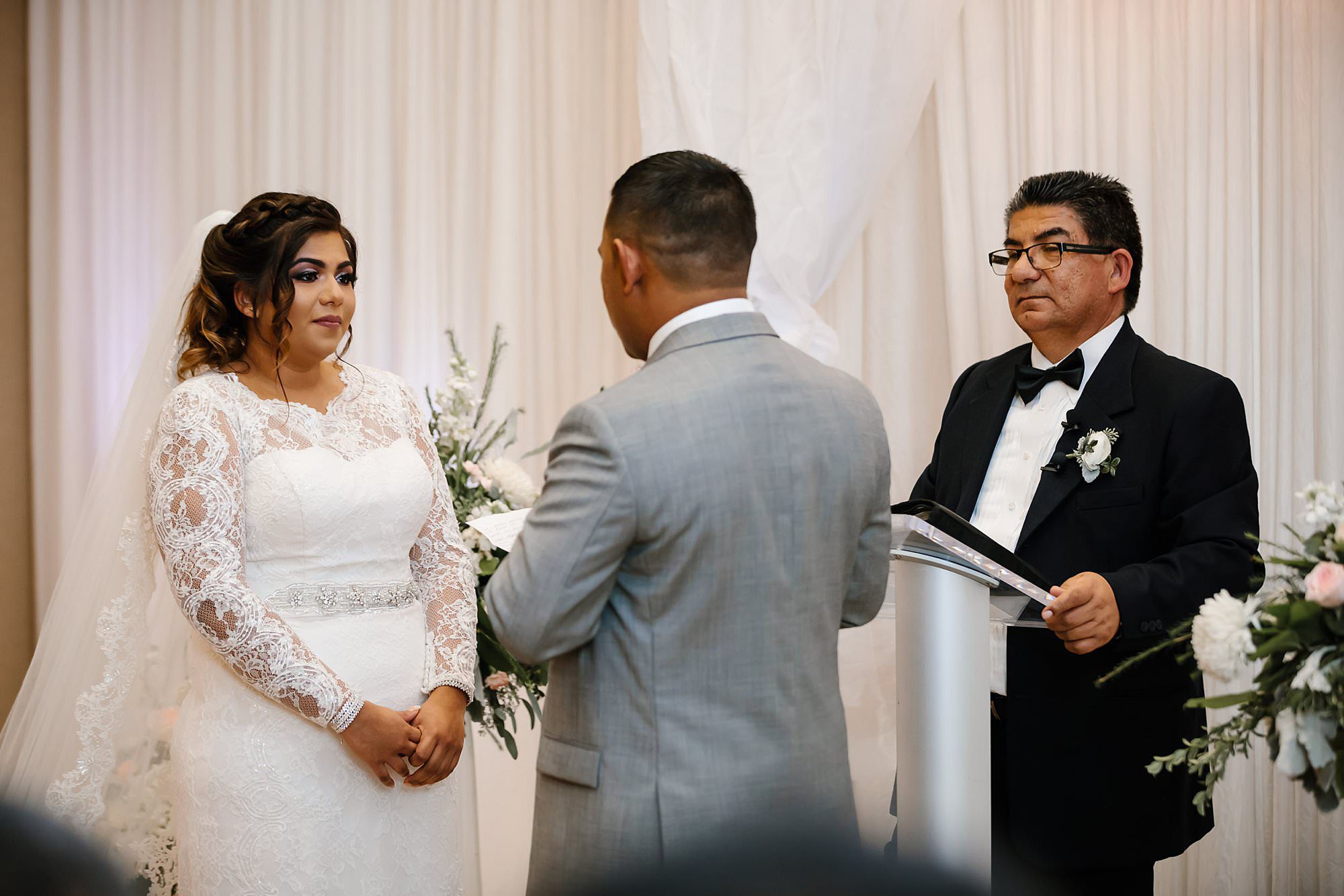 Bride trying not to cry listening to grooms vow