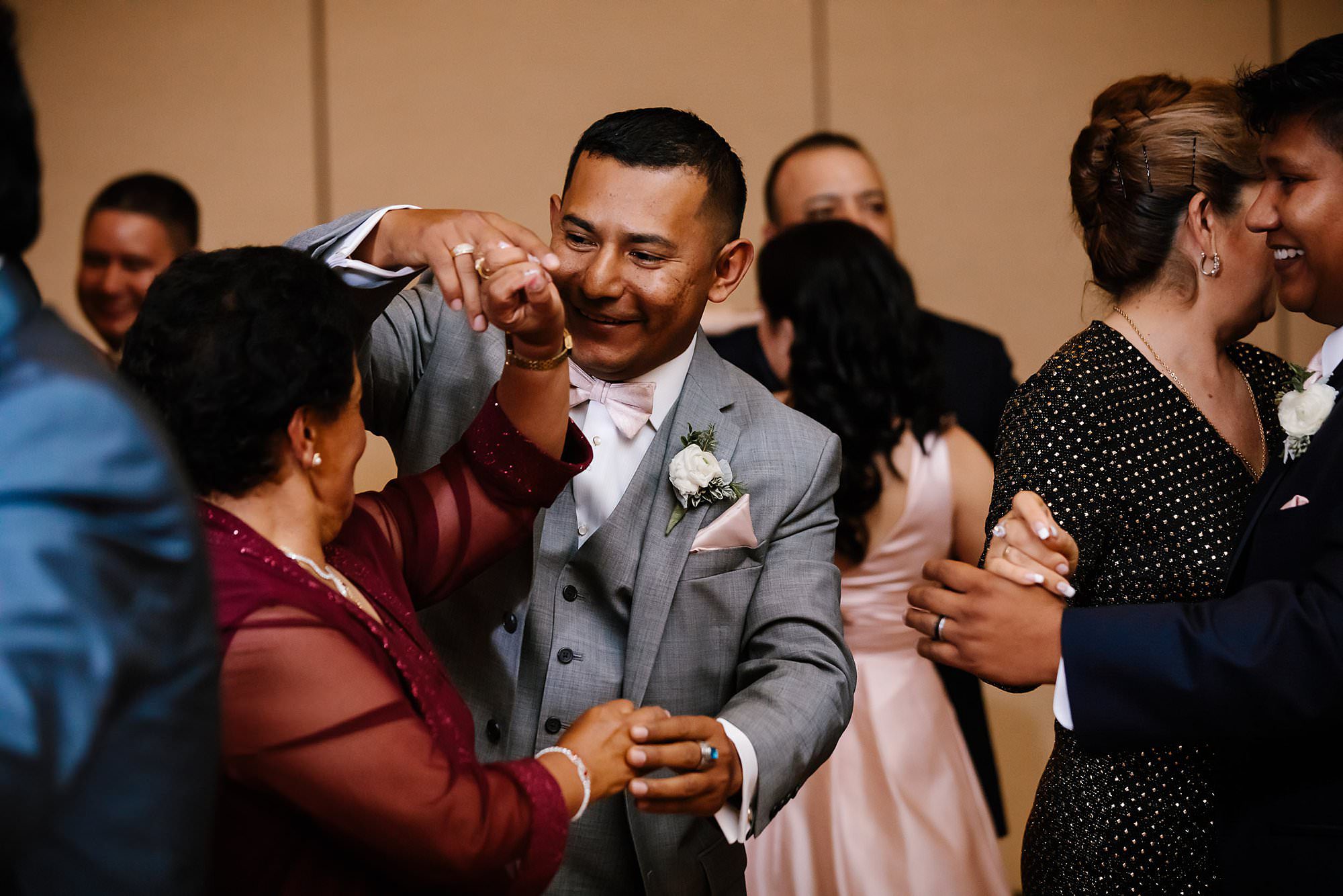 Groom dancing with aunt at wedding