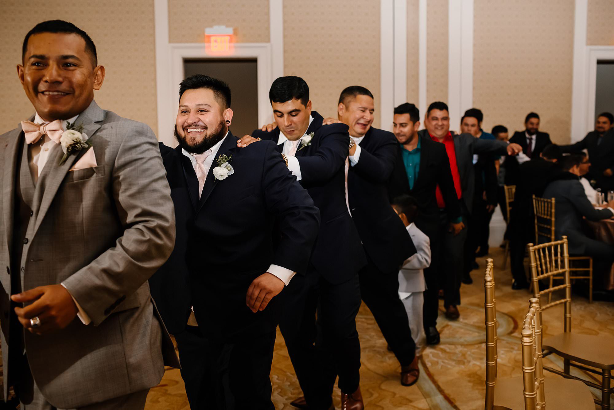 Grooms conga line during reception