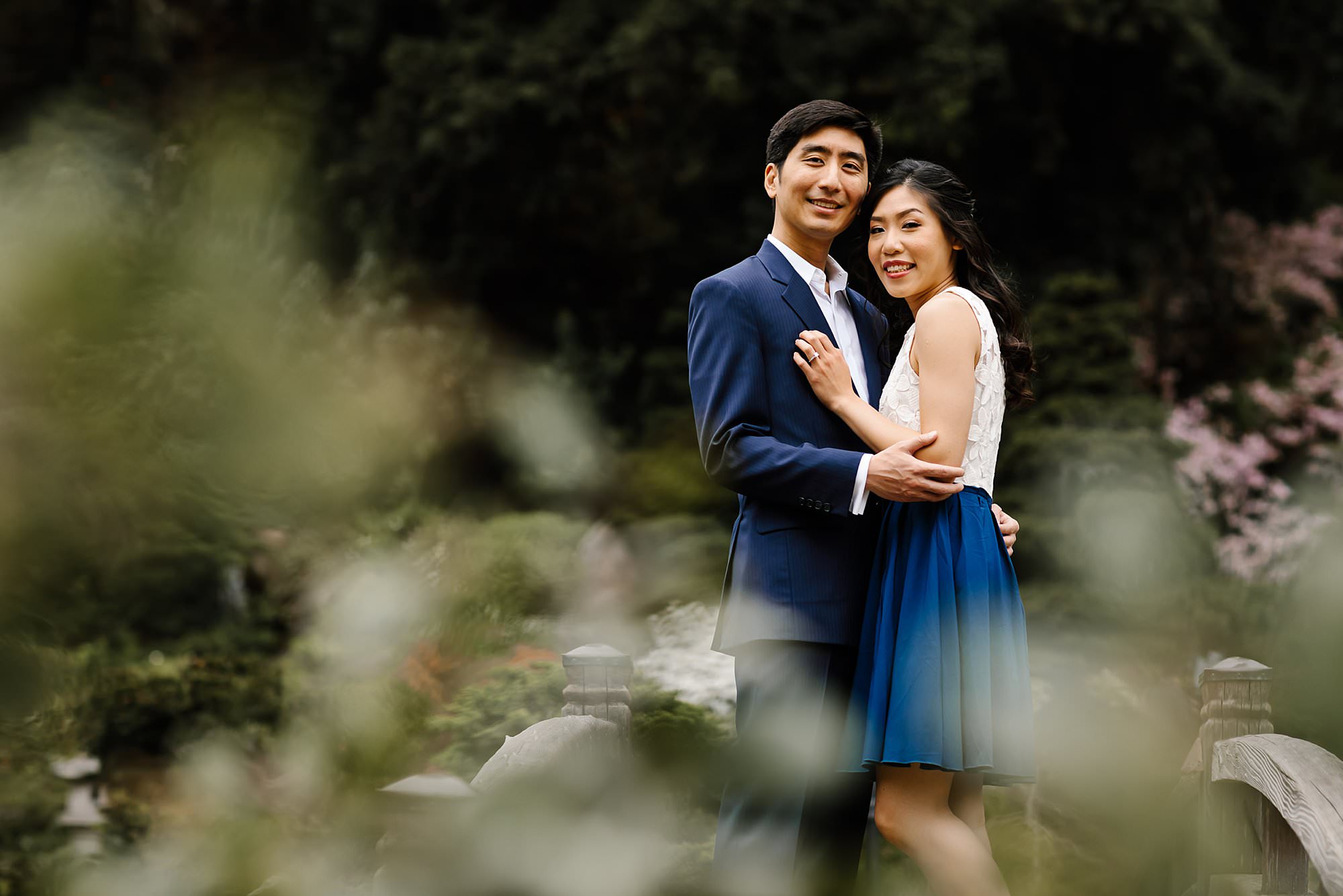 Engaged couple embracing on the bridge in Hakone Estate gardens
