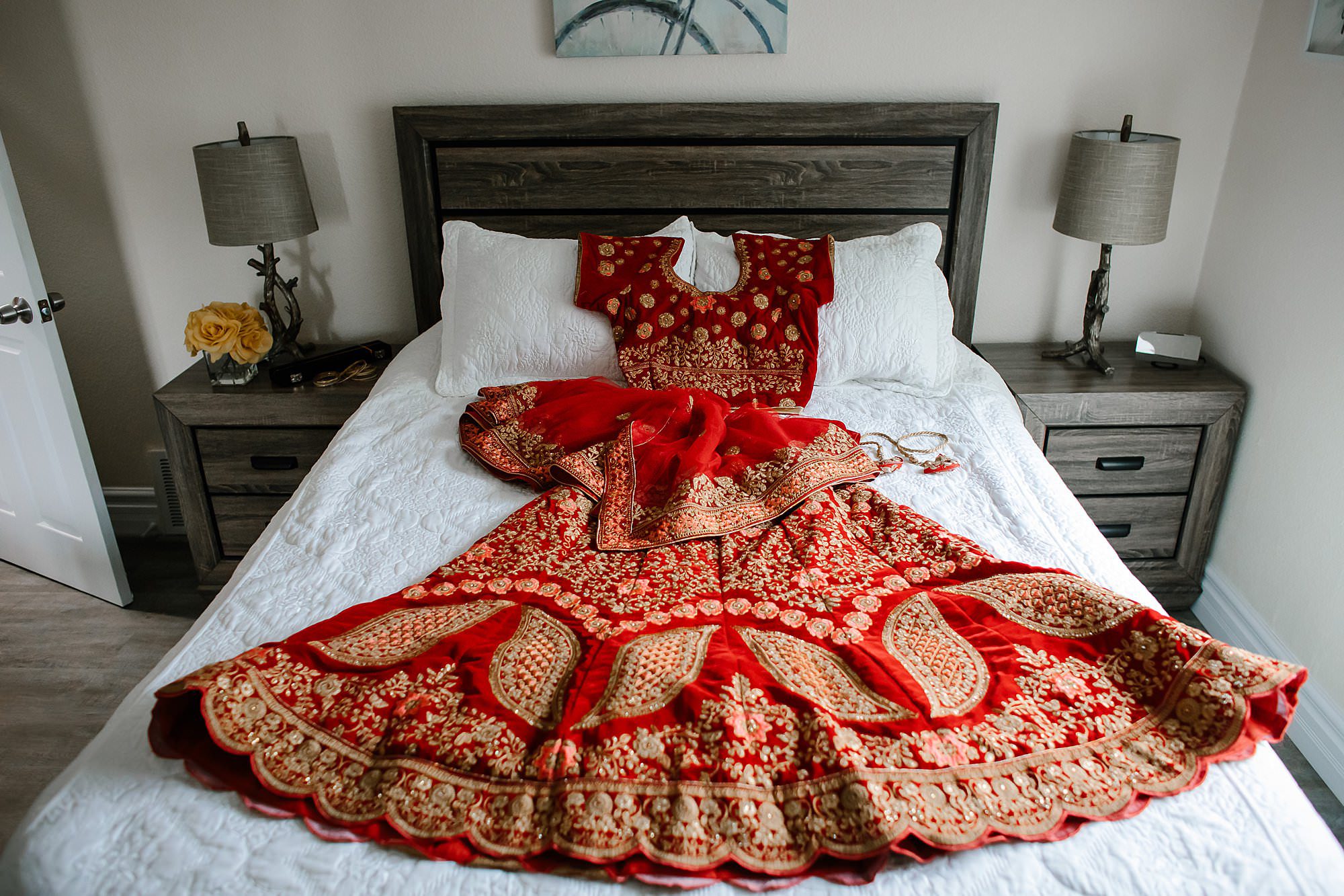 Red and gold Hindu saree on a bed