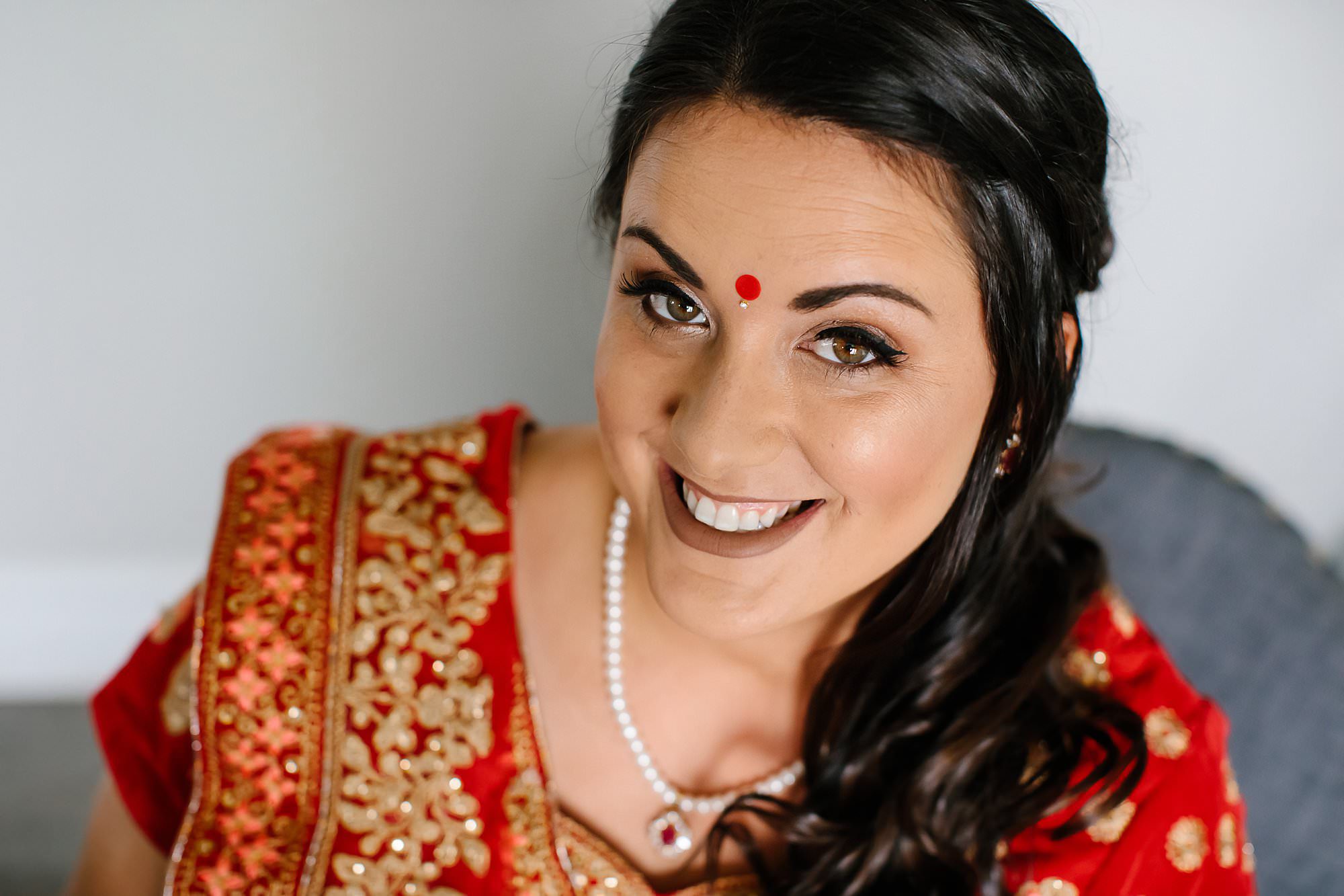 Portrait of bride wearing red and gold saree