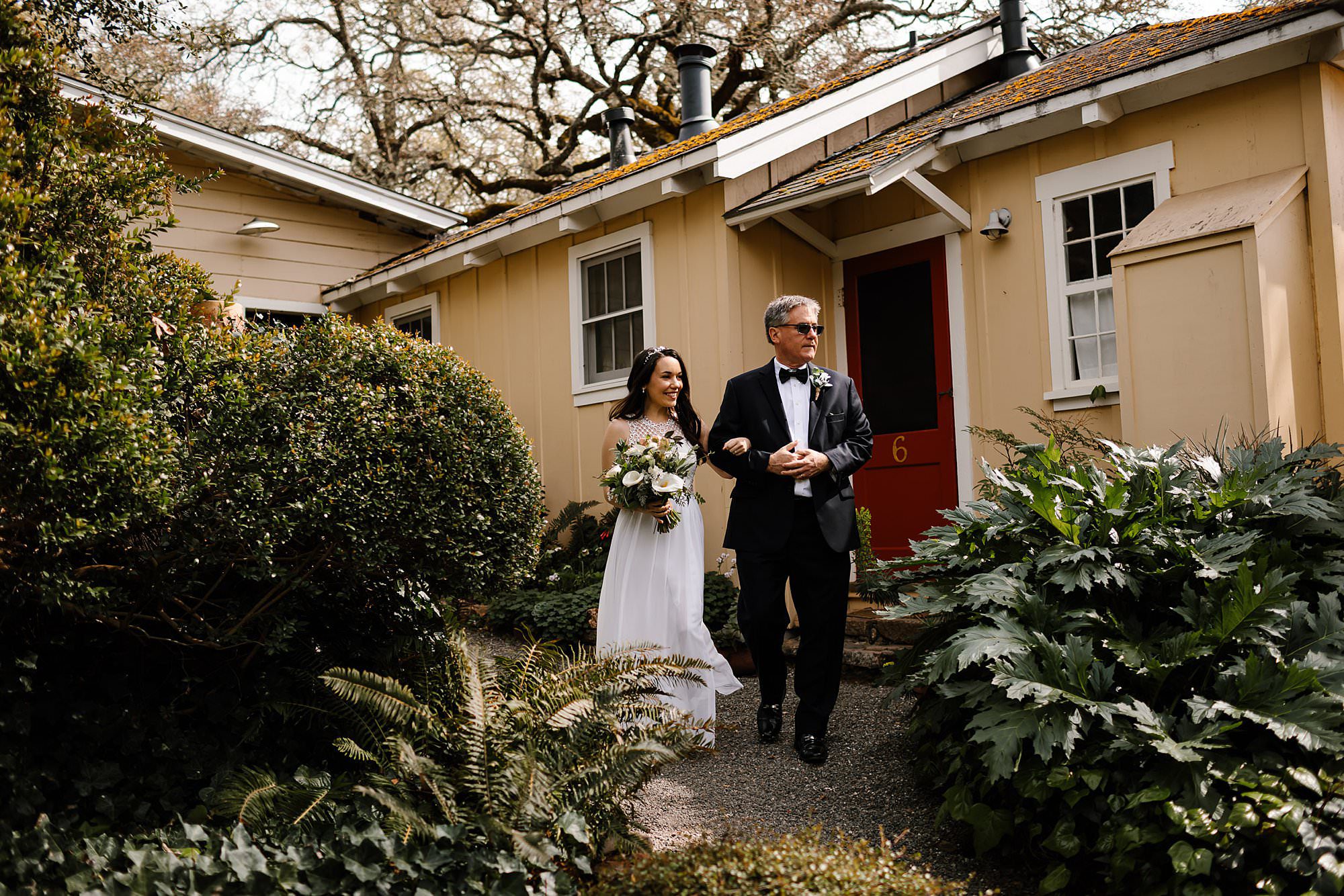 Father escorts the bride from the cottage at Beltane Ranch to the courtyard for an intimate elopement
