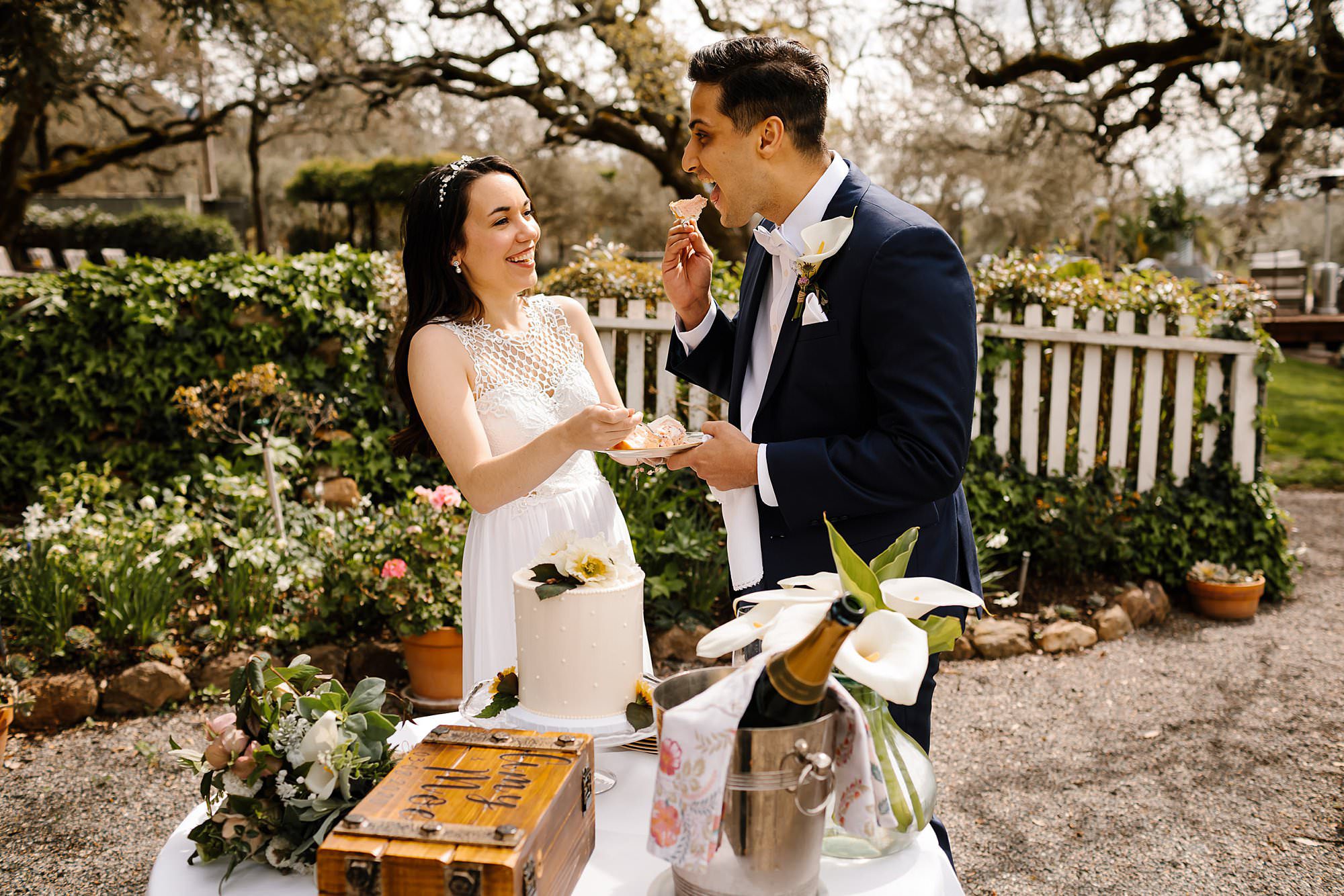 Groom feeds himself cake at an intimate outdoor Beltane Ranch wedding