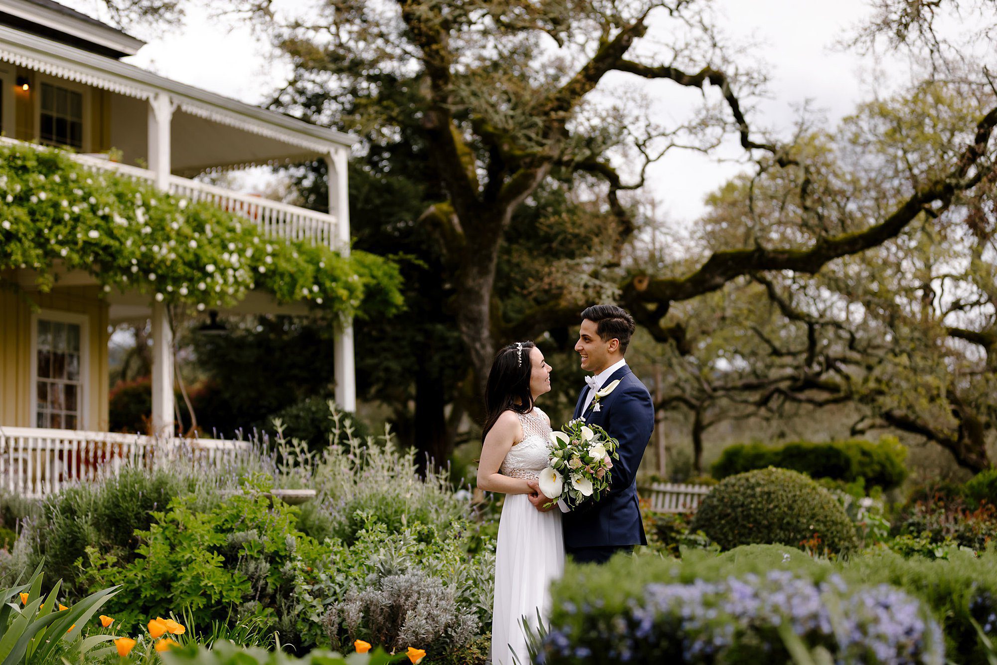 Remove term: Amy and Mo in the garden at Beltane Ranch just after their intimate elopement under the oak Amy and Mo in the garden at Beltane Ranch just after their intimate elopement under the oak