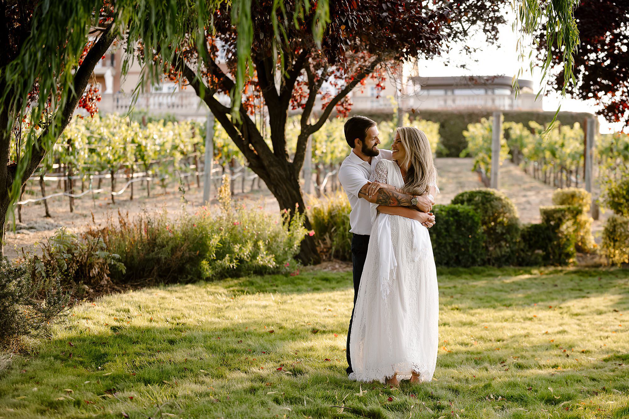 Cameron embraces Melissa at sunset in the garden at Domaine Carneros in Napa