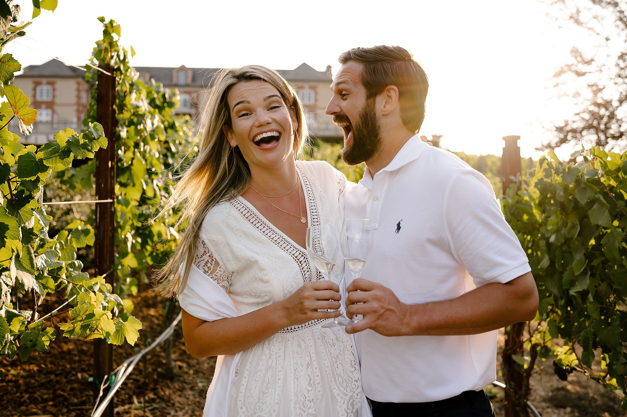Cameron and Melissa laughing in the vineyard at Domaine Carneros in Napa.