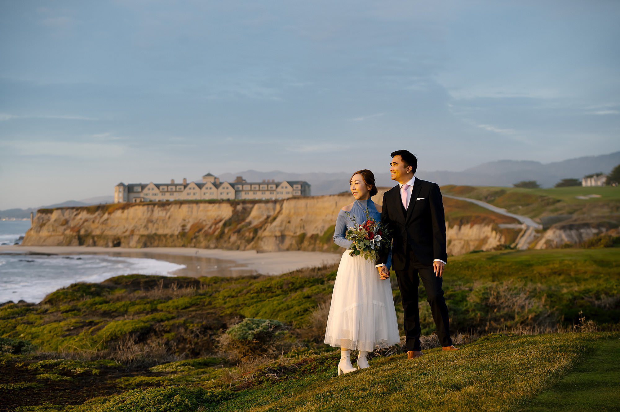 Newlyweds Jason and Melinda admire the sunset on the cliffs above the beach near the Ritz-Carlton in Half Moon Bay