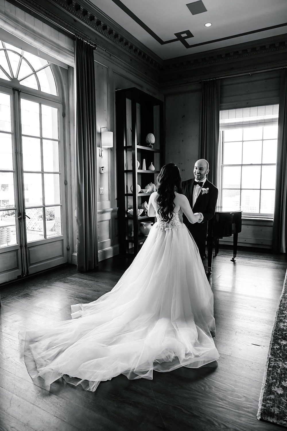 Black and white portrait of Alexis and Rueben's first look in the penthouse at the Fairmont San Francisco before their ceremony