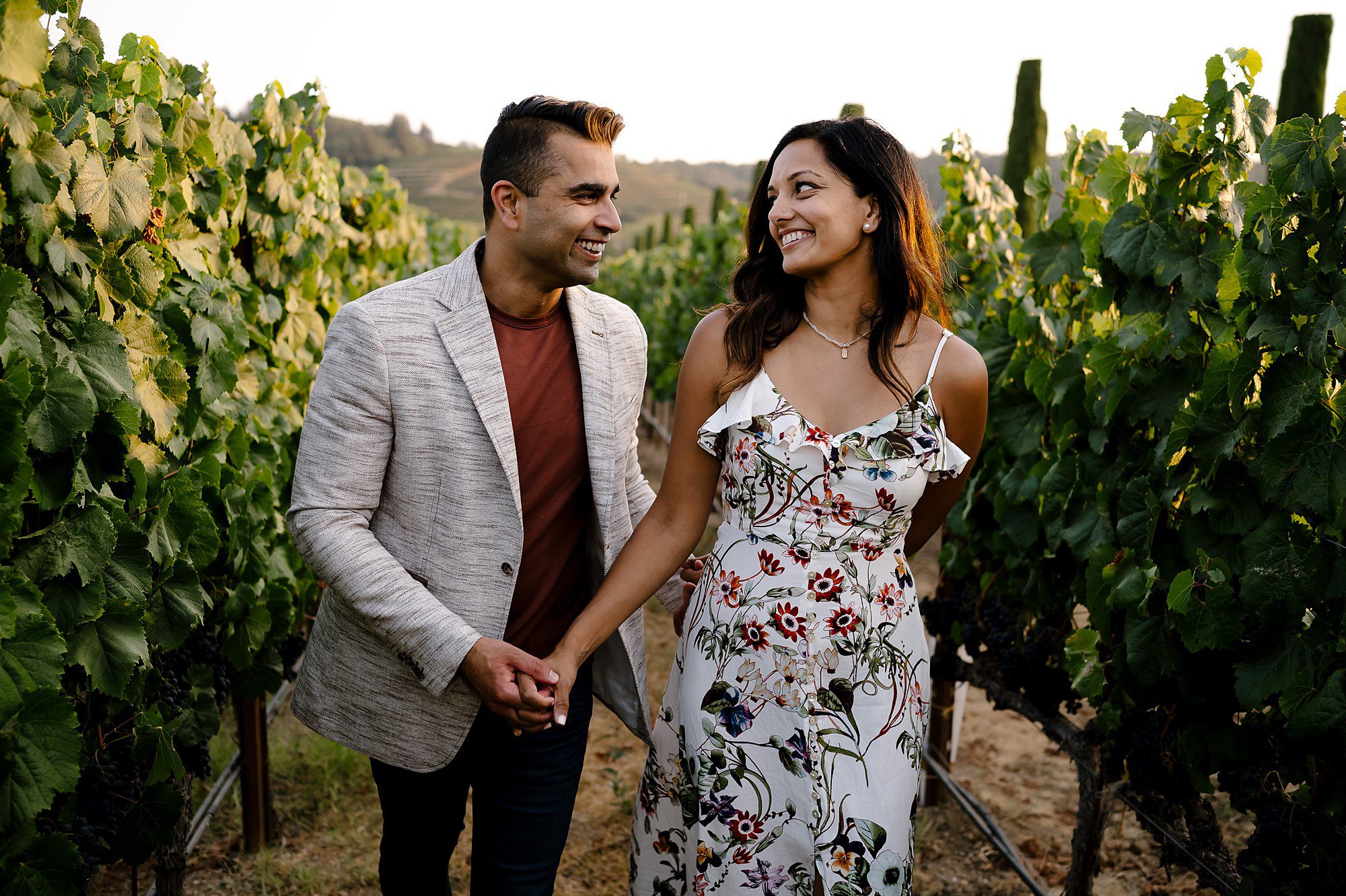 Swati leads Raja through the vineyard at their Ferrari Carano engagement session