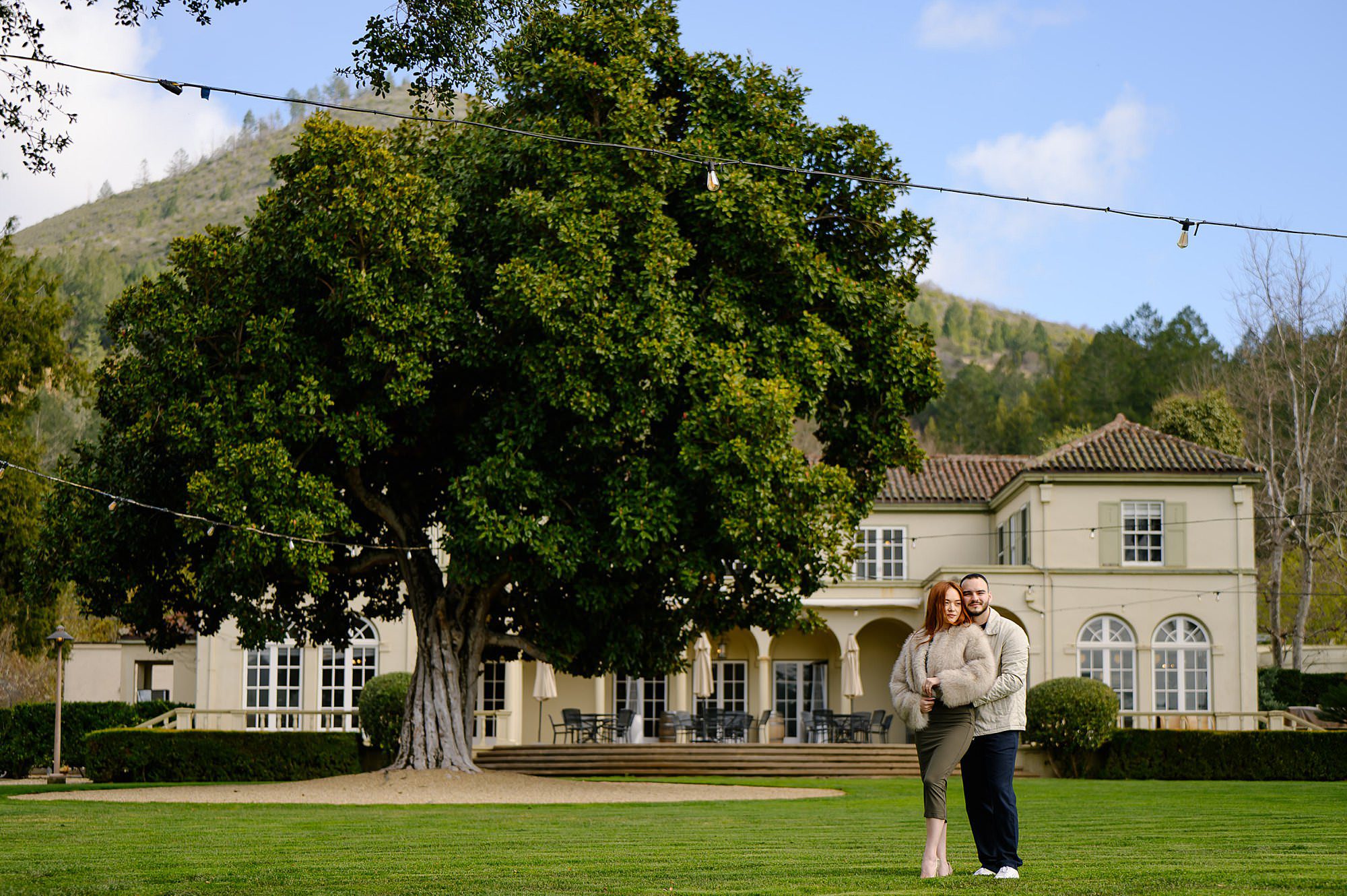Darya and Marko in front of Chateau St Jean after he proposed under the magnolia tree