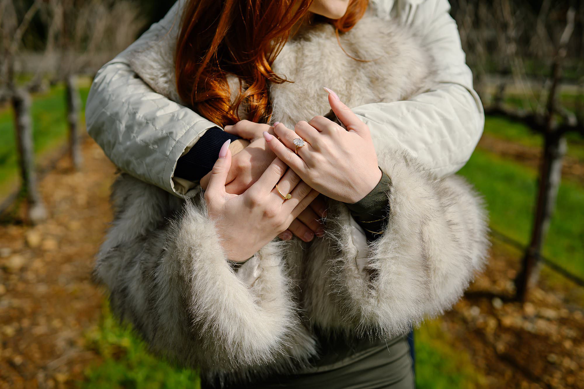 Marko puts his arms around Darya while in the winter vineyard at Chateau St Jean in Kenwood