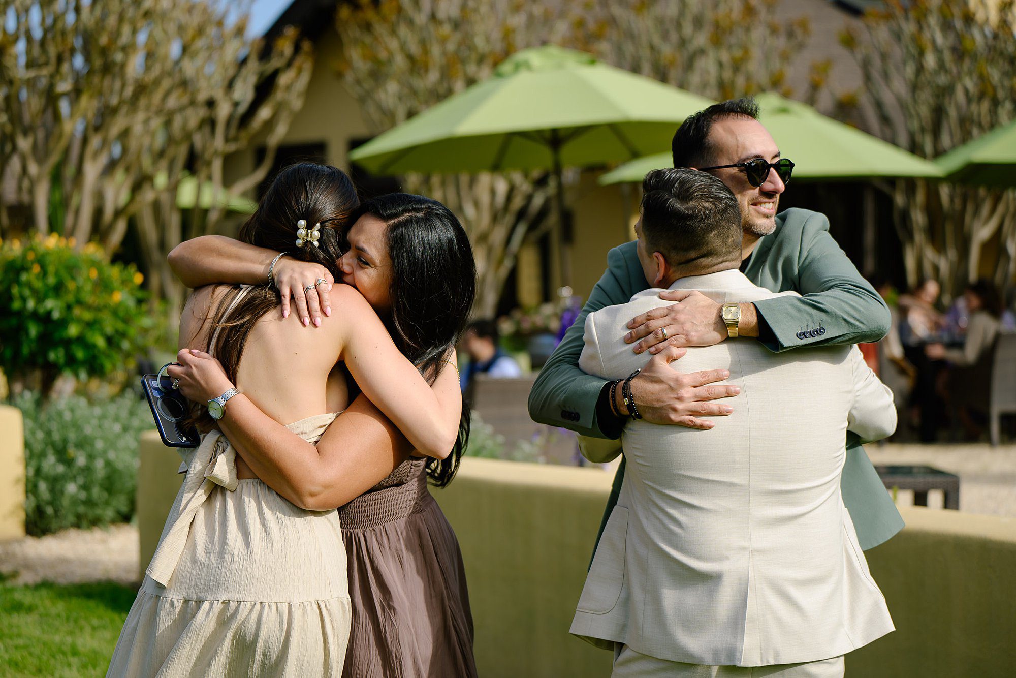 Nik and Jackie are greeted with hugs after he proposed at Landmark Vineyard