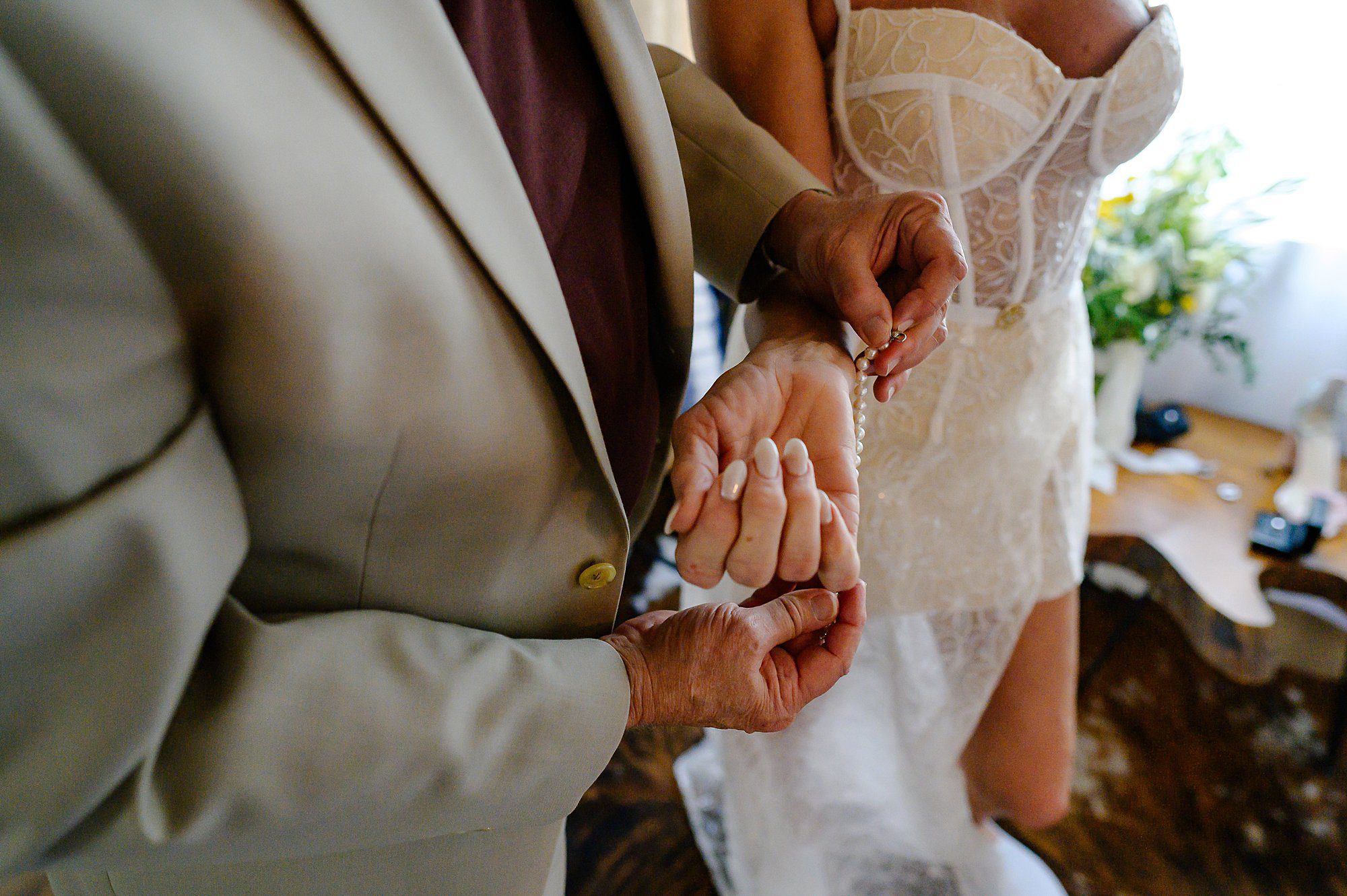 Barry putting on Lynns pearl bracelet in the cottage at Beltane Ranch 