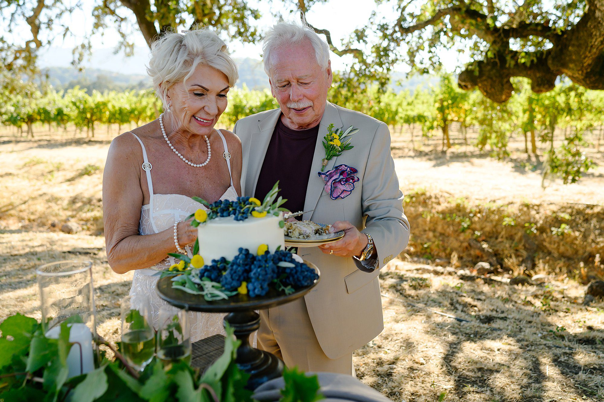 Lynn and Barry cutting the cake after their vineyard elopement at Beltane Ranch