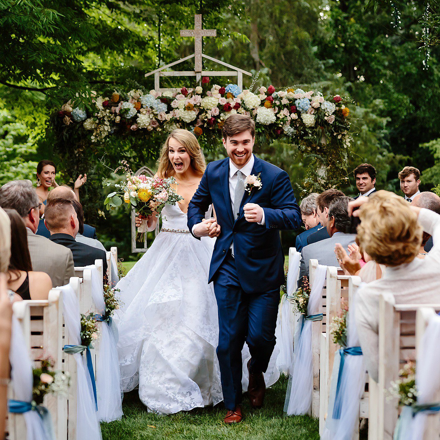 Megan and Turner run down the aisle at their Graylyn Estate Wedding in Winston Salem, North Carolina