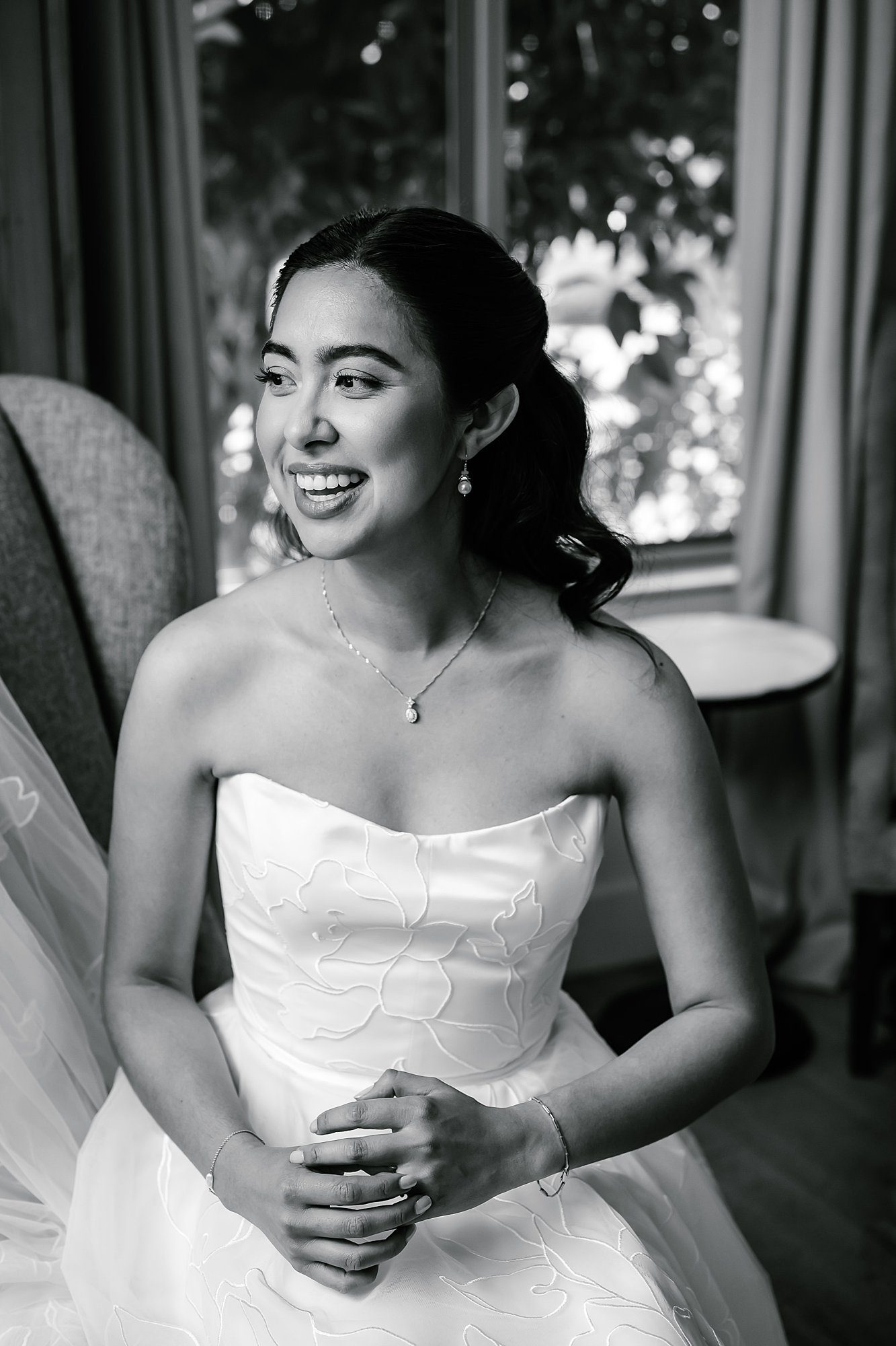 Black and White portrait of Camille sitting in her wedding dress 