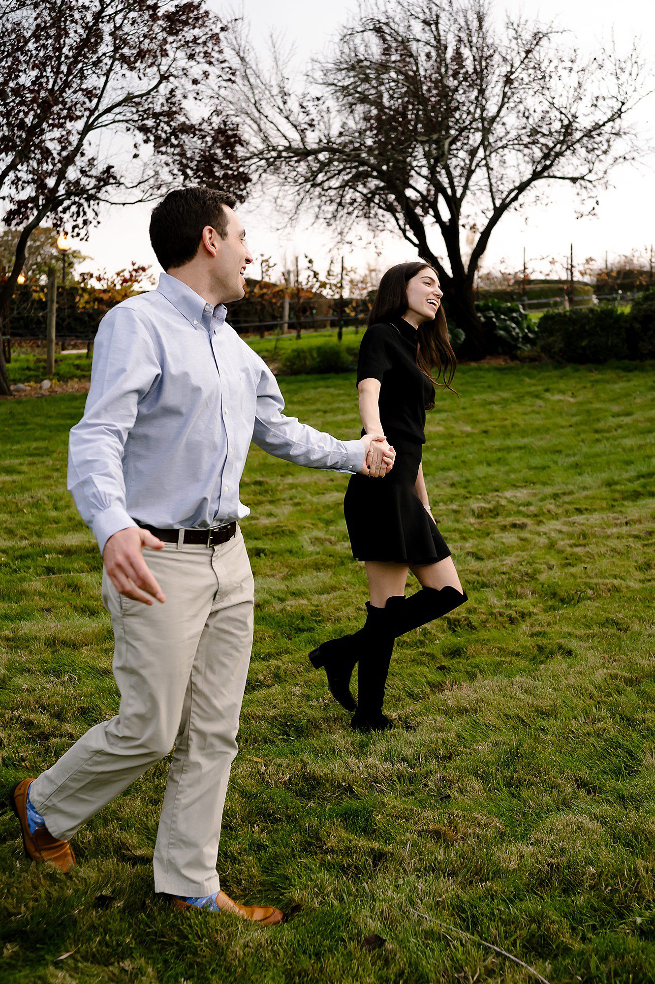 Myles and Julia walking through the garden at Domaine Carneros winery in Napa after he proposed
