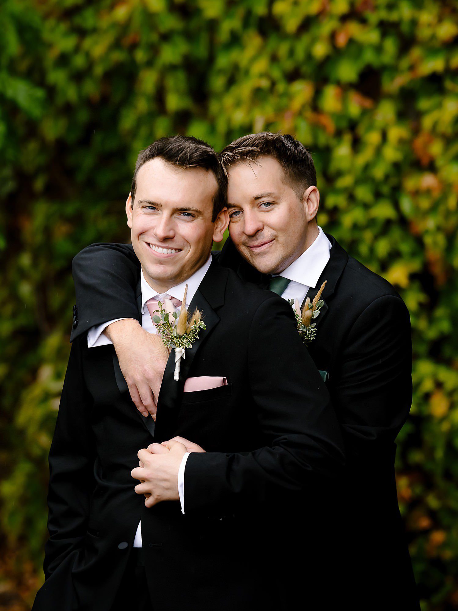 John and Jason embrace in the vineyard at Viansa Winery on their wedding day